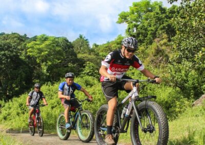 Three Men Riding on Bicycles